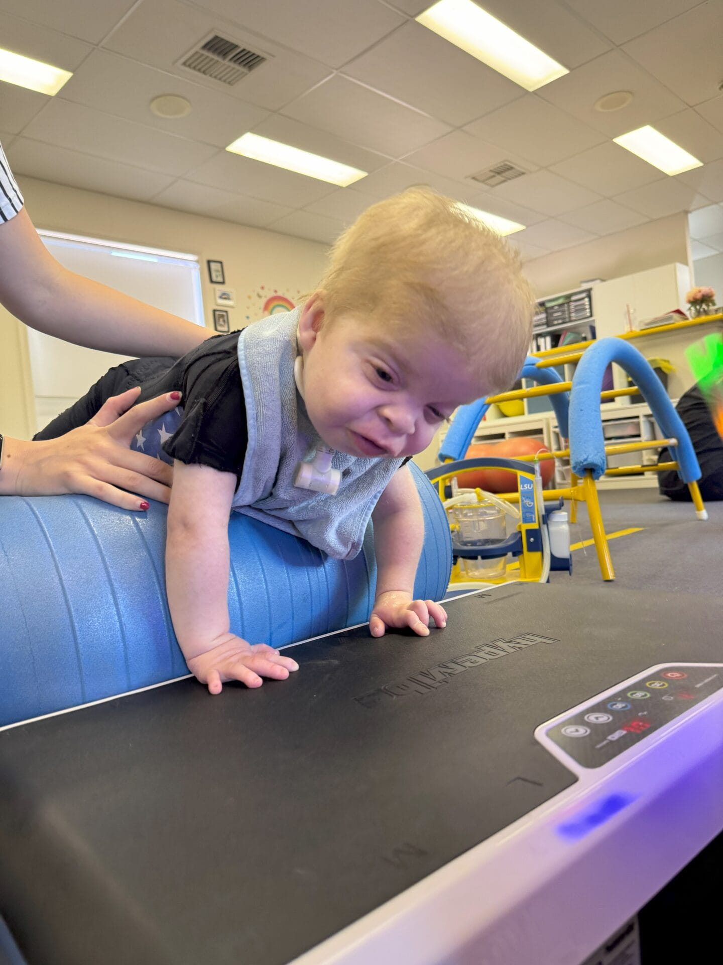 Infant engaging in core therapy using a support roll at Therapies for Kids Developing core strength and head control through play-based therapy.