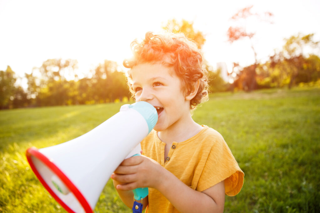 boy standing in field speaking in megaphone 2026 01 09 06 49 24 utc