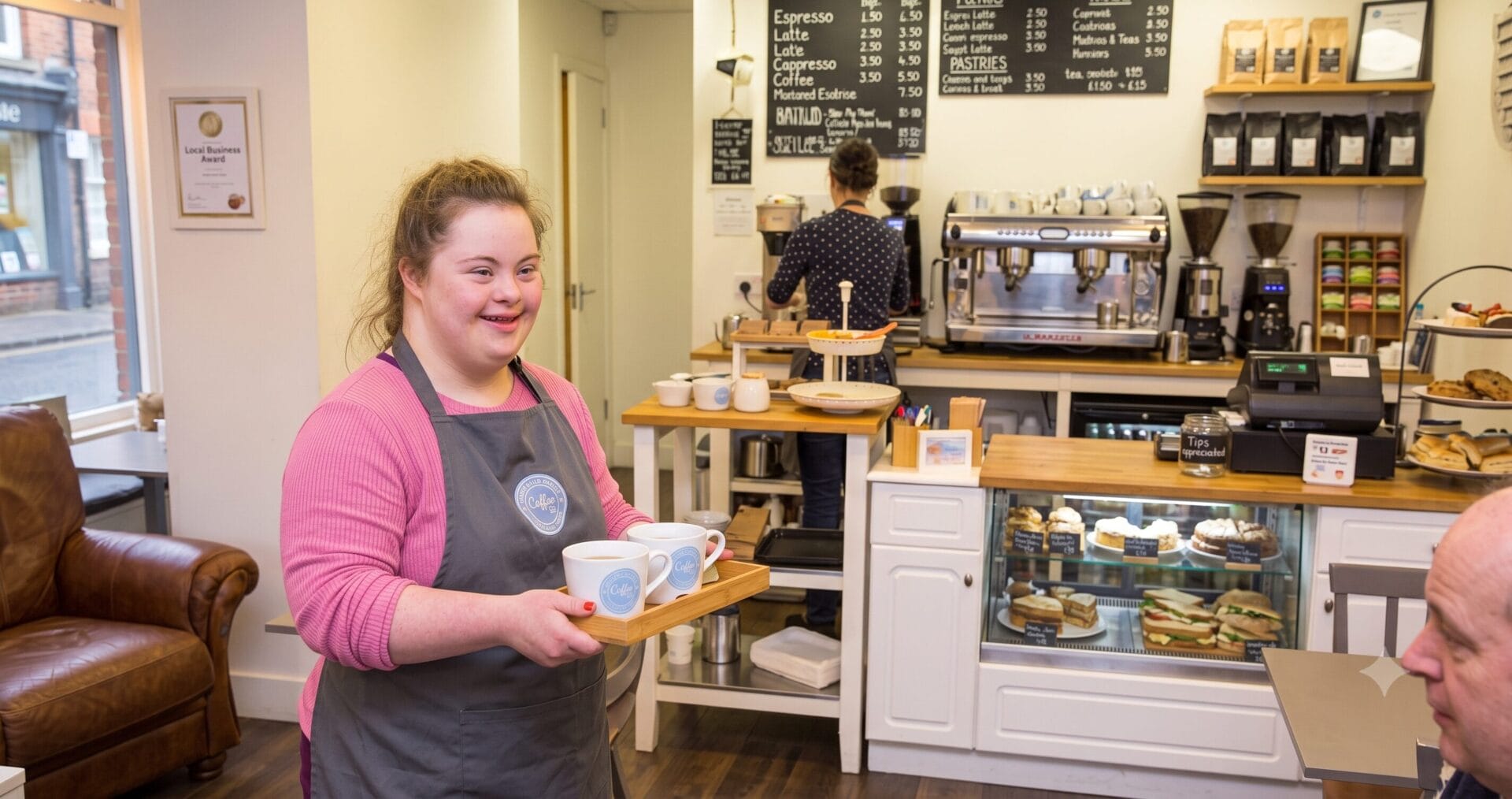 Young woman confidently serving coffee at her workplace